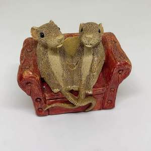 England Surplus Mouse Figurine on a Red Sofa