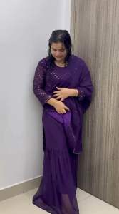 Maroon traditional outfit with intricate white patterns and flared pants. Suitable for formal occasions.