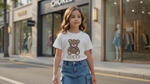 White T-shirt with brown teddy bear graphic design. Casual wear for children.