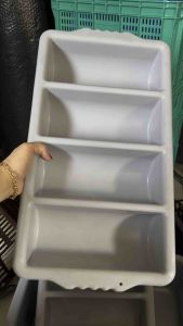 Cutlery organizer with four compartments for spoon and fork storage on kitchen countertop.cutlery organizer with four compartments