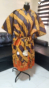 Batik robe with yellow and blue patterns tied waist fits regular body to 2XL size. 26" overlap x 42" high. Made in Indonesia