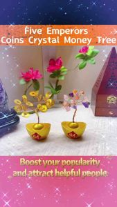 Golden money tree with coin leaves on gold ingot base with Chinese character red square. Colorful crystal tree on gold ingot base with Chinese character red square. Displayed on wooden stand.
