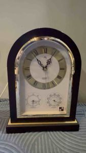 Affordable Citizen Quartz mantel clock featuring a wooden arched case and integrated weather instruments 30x23 cm