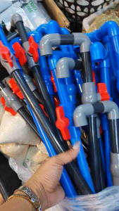Blue and black plastic pipe fittings for overhead aquarium pipes. Multiple lengths and angles. Red valve attachments.