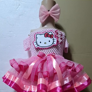 Hello Kitty dress with pink bow and tutu skirt. Off-shoulder design with polka dot ribbons and satin trim.