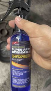 White semi truck engine degreaser machine in garage setting. Engine degreaser for automotive maintenance.