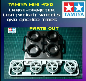 Tamiya Mini 4WD Large-Diameter Lightweight Wheels and Arched Tires. Four white plastic wheels with black tires.