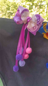 Colorful fabric hair bows with ribbons and pom-poms for kids.