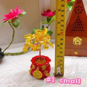 Golden money tree figurines in red pots with gold accents and Chinese coin designs.
