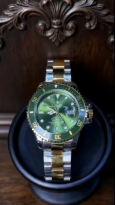 A golden mens watch crafted with a solid golden case and bracelet. The classic green dial is equipped with a Chromalight illumination system. Vintage luxurious modern and water-resistant it is suitable for both business and casual settings.