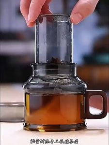 Mini DunDun Glass Teapot with Wooden Handle - Tea Infuser Dark Brown Glass Square Handle Transparent Body Tea Leaves Visible Indoor Setting