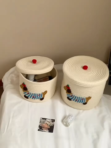 Storage Basket Functional And Stylish For Living Room And Childs Play Area - White with dog design red pom-pom lid soft texture decorative suitable for living room and childs play area.