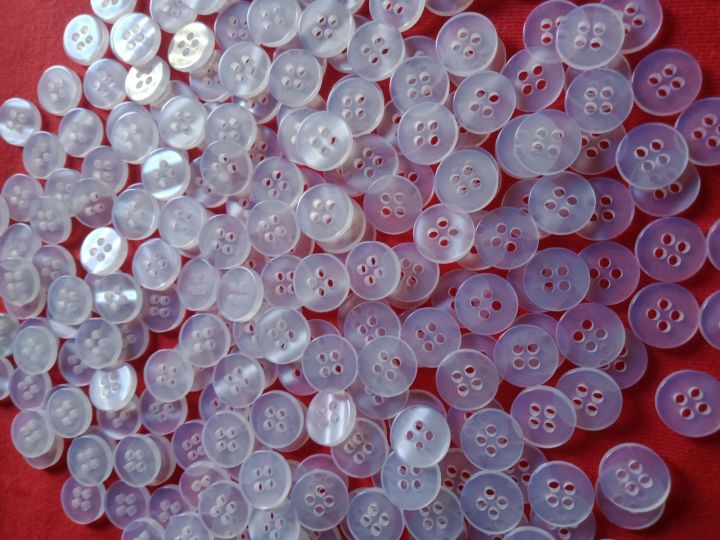Butones polyester button black/clear sold per 100 Pcs . pang school uniforms and polo shirt.