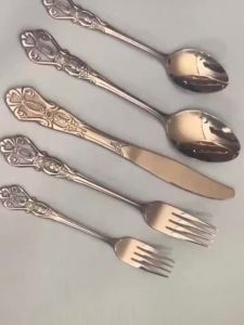 40pcs Elegant Silver Cutlery Set Features Stainless Steel Openwork Handles and Includes Forks Spoons and Knives. Perfect for W