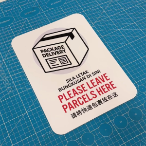 Please Leave Parcels Here. Sila Letak Bungkusan Di Sini. Sticker Sign Notice Delivery Package Pos Parcel Drop