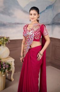 Pink embroidered ethnic blouse with floral patterns and round neckline.