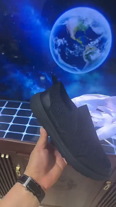 Black slip-on mesh shoe with rubber sole. Breathable design. Casual sports shoes