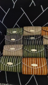 Handmade woven sling bags with striped pattern in green brown beige and black colors.