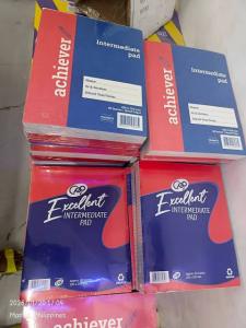 10 PadsGrade 1-4 paper Achiever - 100 Sheets - Blue Cover - White Label - For School Use - Stacked on Floor