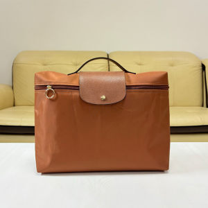 The 2025 new nylon hand-held briefcase fashionable dumpling-shaped handbag is suitable for business commuting can hold a 14-inch laptop is foldable and can be used as a casual document bag.