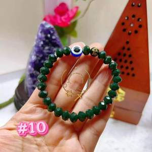 Green beaded bracelet with red and blue accents.