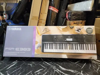 Brandnew Yamaha PSR383 PSR283 electronic keyboard with 61 keys LCD display and control buttons.