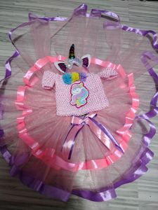 Unicorn-themed pink knitted dress with tutu skirt and ribbon accents.