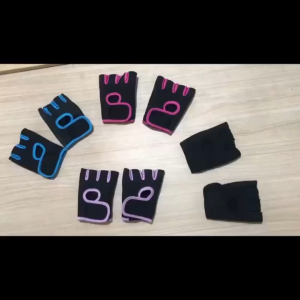 Black and pink exercise gloves with adjustable fit for indoor fitness classes and home workout sessions.