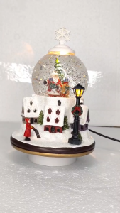 ONELINE #FC703 A festive Christmas snow globe featuring a winter village scene a Santa Claus figurine inside the glass dome christmas decor