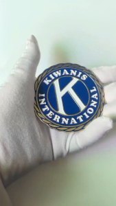 KIWANIS INTERNATIONAL lapel Emblem with blue and gold design.