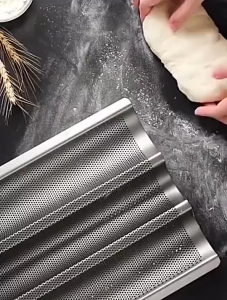 Silver 4-slot carbon steel baguette mold helping to bake crispy baguettes