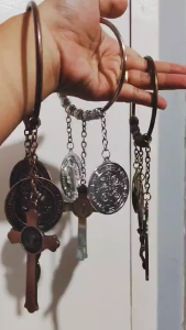 St. Benedict Miraculous Medal Door Knob Hanger. Designed to hang on your door handle it serves as a powerful Catholic symbol against bad luck evil and negative energy.