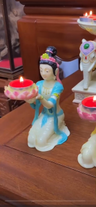 Offering to the Buddha paying respects to the fairy lighting the incense burner the lotus-shaped wax oil lamp stand the flying fairy lamp frame the lotus-shaped lamp base the wax candle stand