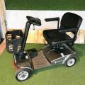 Electric mobility scooter with black seat and basket. 110cm length, 52cm width, 97cm height. Adjustable armrests and footrest.. 