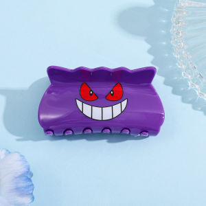 A hair clip themed around the Pokémon "Gengar". It can be used to hold hair in place and is perfect for Pokémon enthusiasts.