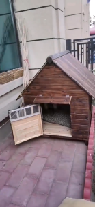 Outdoor solid wood dog house. Large dog house made of preservative-treated wood