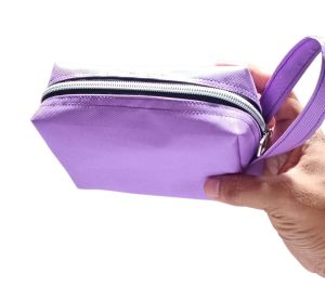 Purple fabric pouch with zipper and wrist strap for travel or daily use.