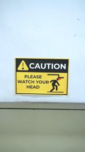 Dsign Caution Please Watch Your Head 10 x 7 Inches | Sticker Signage | Warning Sign| Waterproof| Wall sticker