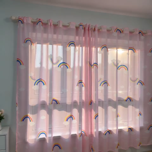 White sheer curtain with rainbow patterns for home window treatment.