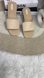 Slide sandals Key attributes: Square toe Embossed pattern Flat sole Fit/use: Casual wear Easy slip-on Scene: Displayed on textured surface with books