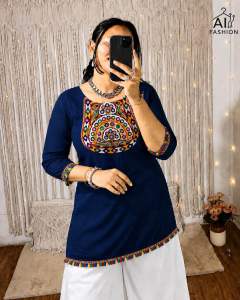 Rayon cotton mirror work short kurti for Navratri Garba with lace work. Maroon color with colorful embroidery on neckline and sleeves. White pants.