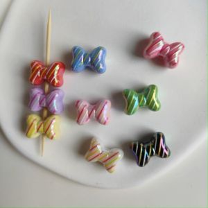 ตัวคั่น  ลูกปัดโบว์ ขนาด 11x15mm รูขนาด 2mm อุปกรณฺเสริมงานฝีมือ งาน DIY ใช้สำหรับการร้อย พวงกุญแจ ที่ห้อยกระเป๋า ที่ห้อยโทรศัพท์