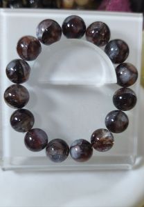LITTLE D FIRE QUARTZ NATURAL CRYSTAL BRACELET with edgy heart centerpiece featuring brown and clear beads silver accents and a silver charm.