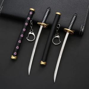 Bandai | Clothing and accessories related to the One Piece anime including a sword-shaped keychain made of metal key accessories