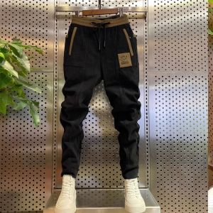 กางเกงลำลองผู้ชายหล่อเท่ฮิตในเน็ตกางเกงจั๊มข้อเท้าผ้าลูกฟูกเข้ารูปแบบใหม่ฤดูใบไม้ผลิและฤดูใบไม้ร่วงกางเกงกีฬาฮาเร็มเก้าส่วนแบบผู้ชาย