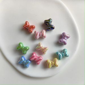 ลูกปัดตัวคั่น  ลูกปัดโบว์ ขนาด 11x15mm รูขนาด 2mm อุปกรณฺเสริมงานฝีมือ งาน DIY ใช้สำหรับการร้อย พวงกุญแจ ที่ห้อยกระเป๋า ที่ห้อยโทรศัพท์