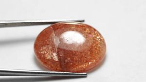 12.40 ct พลอยดิบ ซันสโตน (Sun Stone) ทรงไข่หลังเบี้ย สีแดง ส้ม แอฟริกา