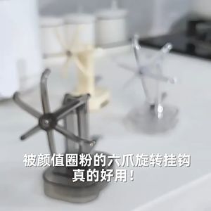 Kitchen Suction Cup Rotating Six-Claw Hook Rack for hanging utensils and towels in a modern kitchen setting.