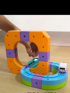 Magnetic building block track train set with colorful tracks and toy trains for children.