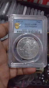 1907-S PCGS AU58 U.S. Philippines Peso coin encapsulated in protective holder.